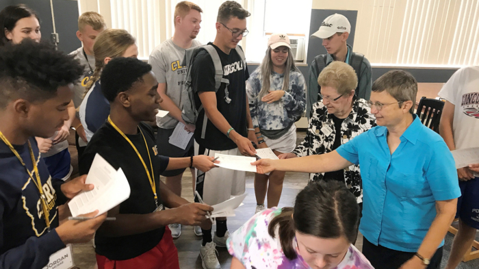 Clarke University students present letters to BVM sisters.