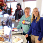 A Clarke University professor and student shares a meal with Georgeann (Immaculate) Quinlan, BVM (middle) at Mount Carmel.