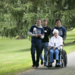 Clarke University students escort Eileen (Rose Francis) Anglim, BVM to the Mount Carmel cemetery to visit her dear friends.